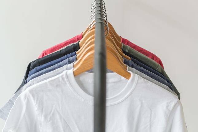 High-quality t-shirts hanging on a clothing rack.