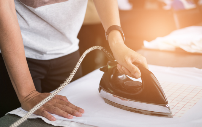 Person ironing a shirt from ShirtSpace.